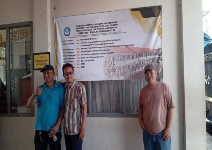 guru dan warga setempat menunjukkan papan informasi yang sudha terpasang sejak awal